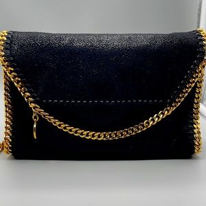 Authentic Stella McCartney black with gold crossbody purse.